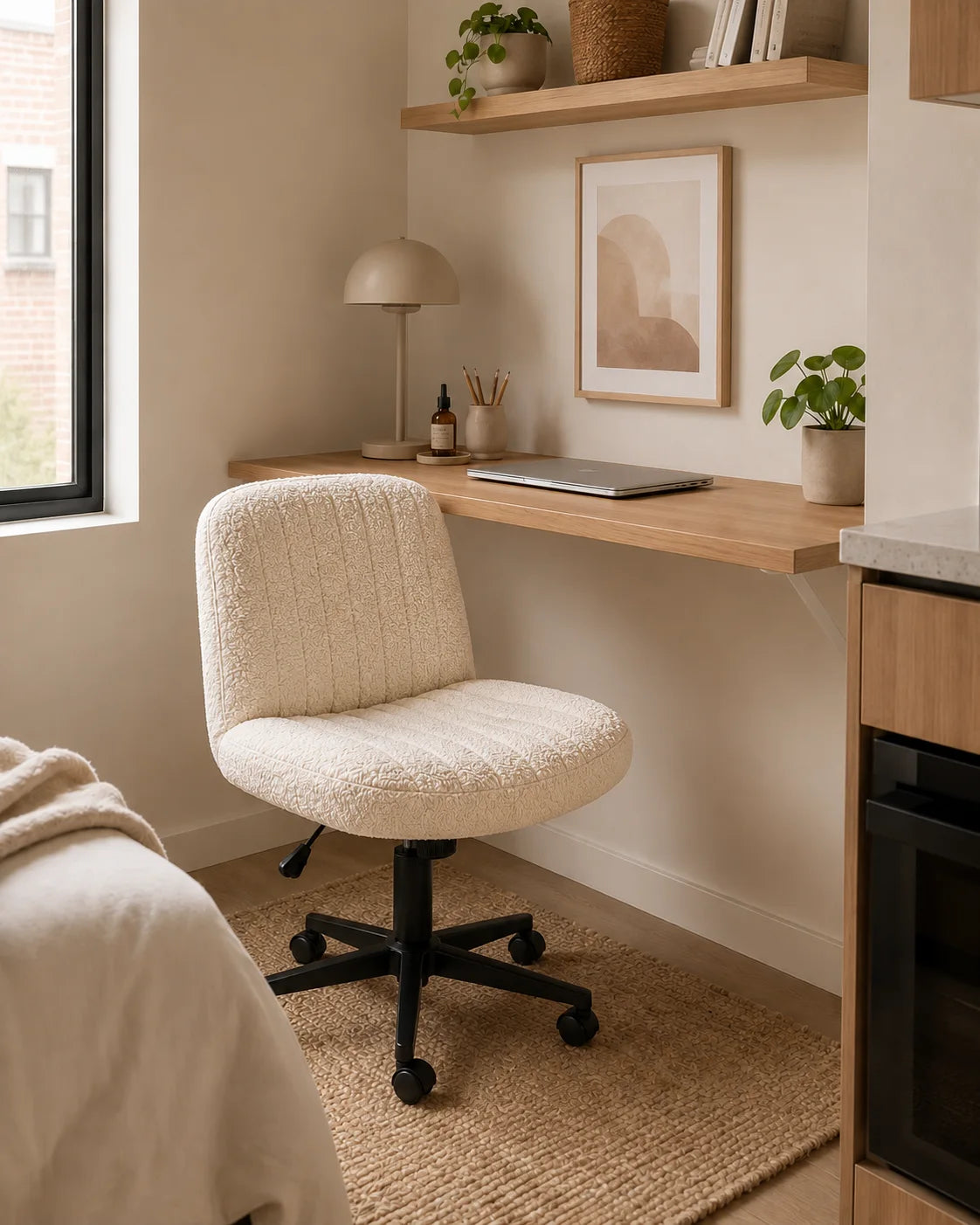 Cream textured MiraForm armless swivel chair beside a light oak desk